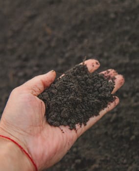 Man holding soil in his hands. Selective focus. Nature.