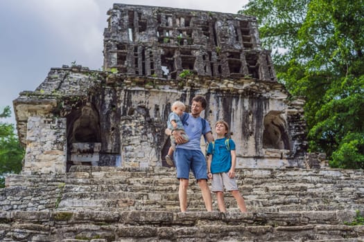 Father with his toddler and teenage sons exploring the ancient pyramids of Palenque, Mexico, surrounded by dense jungle. Cultural heritage and adventure travel concept.