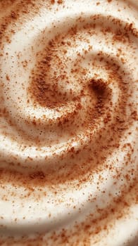 Close-up of swirling whipped cream with cocoa sprinkles.