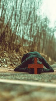 Woman lies peacefully on a forest path, surrounded by nature and a large red cross, evoking spirituality and faith