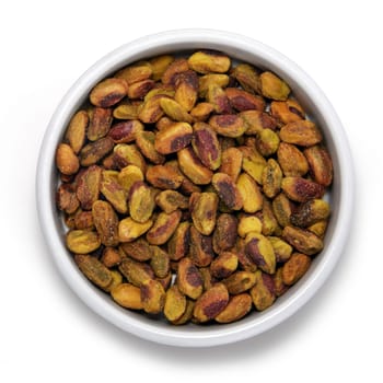 Pistachio nuts in round container on a white background