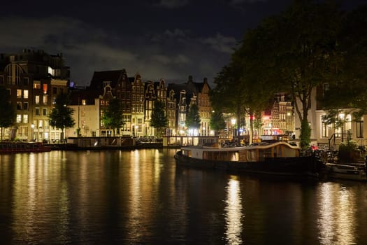 Majestic Amsterdam at night. Summer city landscape. Panorama.