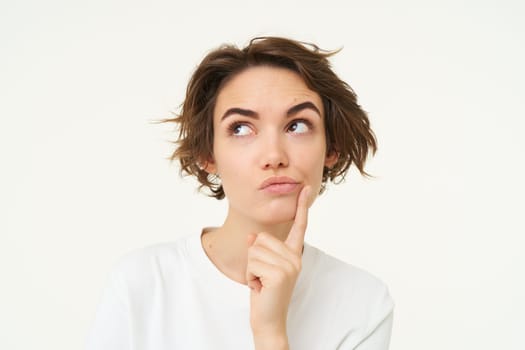 Close up portrait of woman with thoughtful face, thinking of solution, pondering, making choice, standing over white studio background.