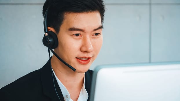 Business people wearing headset working in office to support remote customer or colleague. Call center, telemarketing, customer support agent provide service on telephone video conference call. Jivy