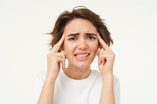 Image of woman in panic thinking, brainstorming, trying hard to remember something, standing over white background.