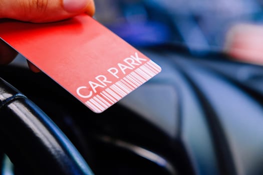Driver is holding parking card getting ready to exit parking