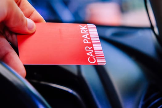 Driver is holding parking card getting ready to exit parking