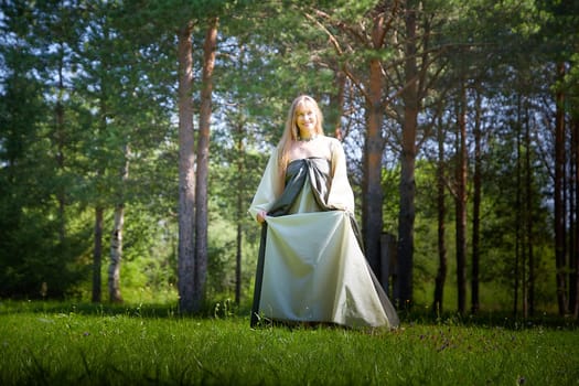 Beautiful dryad or fairy in nature. Pagan spirit of forest. Environmental friendliness, caring for nature. Adult mature woman 40-60 in Photo shoot