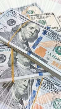 A Fan of $100 Bills.A close-up photo of a fan of $100 US dollar bills. The bills are arranged neatly, with the portrait of Benjamin Franklin visible on each bill. The background is white.Finance ve economy concept.