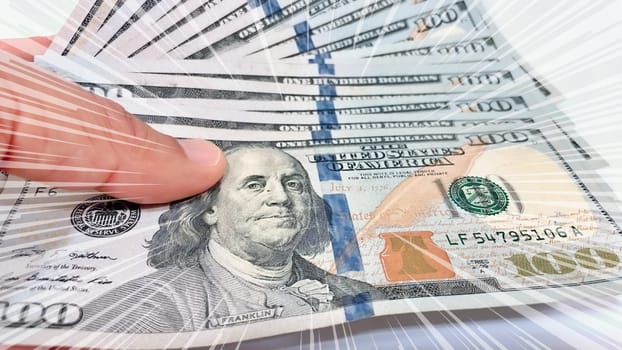 A Fan of $100 Bills.A close-up photo of a fan of $100 US dollar bills. The bills are arranged neatly, with the portrait of Benjamin Franklin visible on each bill. The background is white.Finance ve economy concept.