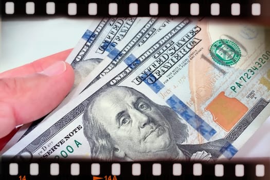 A Fan of $100 Bills.A close-up photo of a fan of $100 US dollar bills. The bills are arranged neatly, with the portrait of Benjamin Franklin visible on each bill. The background is white.Finance ve economy concept.