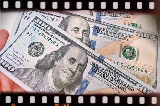 A Fan of $100 Bills.A close-up photo of a fan of $100 US dollar bills. The bills are arranged neatly, with the portrait of Benjamin Franklin visible on each bill. The background is white.Finance ve economy concept.