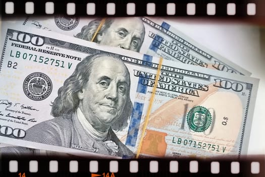 A Fan of $100 Bills.A close-up photo of a fan of $100 US dollar bills. The bills are arranged neatly, with the portrait of Benjamin Franklin visible on each bill. The background is white.Finance ve economy concept.