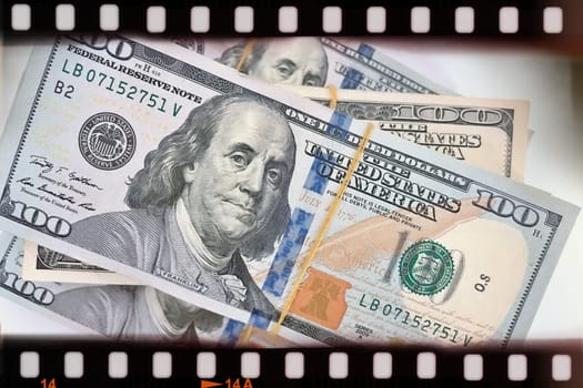 A Fan of $100 Bills.A close-up photo of a fan of $100 US dollar bills. The bills are arranged neatly, with the portrait of Benjamin Franklin visible on each bill. The background is white.Finance ve economy concept.