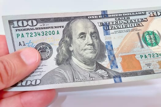 A Fan of $100 Bills.A close-up photo of a fan of $100 US dollar bills. The bills are arranged neatly, with the portrait of Benjamin Franklin visible on each bill. The background is white.Finance ve economy concept.