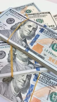 A Fan of $100 Bills.A close-up photo of a fan of $100 US dollar bills. The bills are arranged neatly, with the portrait of Benjamin Franklin visible on each bill. The background is white.Finance ve economy concept.