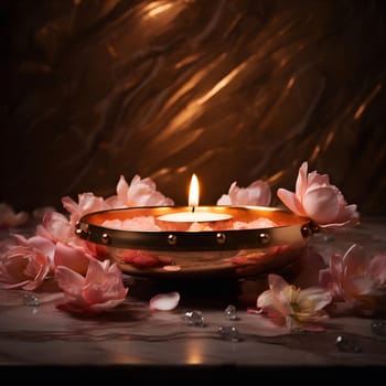 A single candle glows in a gold bowl surrounded by delicate pink flower petals, creating a peaceful and romantic atmosphere.