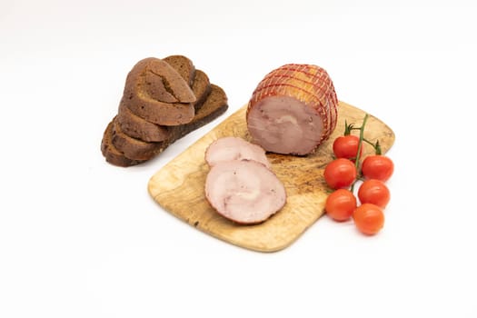 Smoked Turkey roll with herbs on a wooden background.