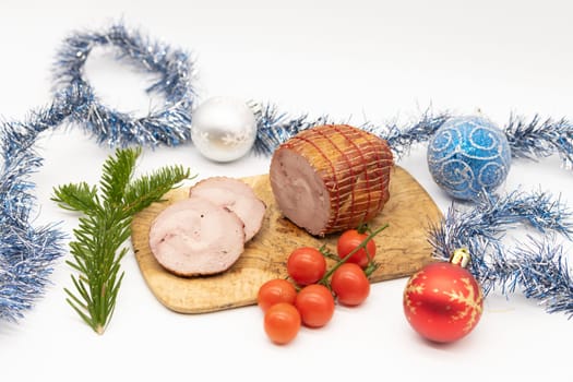 Smoked Turkey roll with herbs on a wooden background.