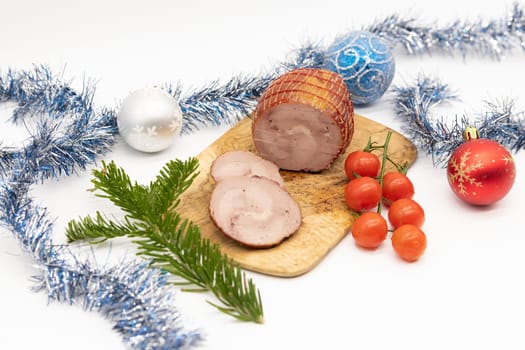 Smoked Turkey roll with herbs on a wooden background.