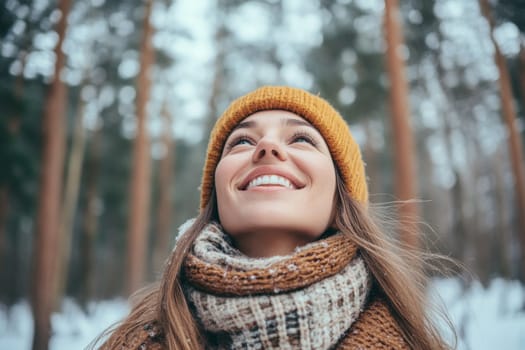 Beautiful sweet girl smiling, standing in winter forest or snowy park. She has happy relaxed face. Woman enjoying walk, breathing fresh frosty air. High quality photo