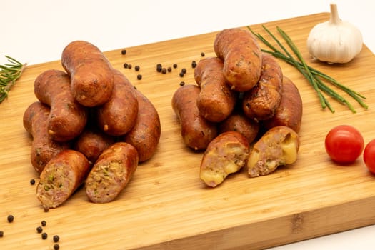 Savor the delightful and rich flavor of gourmet sausages that are perfectly arranged on a beautiful cutting board