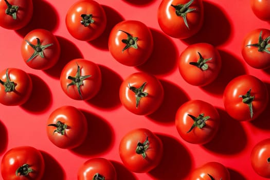 Red juicy tomatoes on a red background. High quality photo