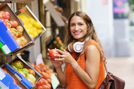 Latin beauty woman shopping fresh fruits and vegetables at organic food market