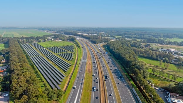 Aerial from traffic on the highway A1 with solar panels on the site in the Netherlands