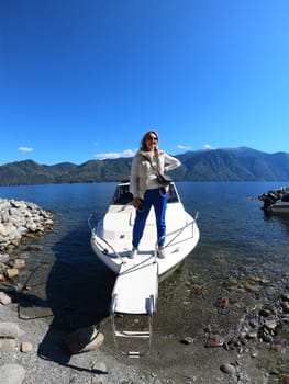 Mature woman on a boat in a lake in Altai, Russia