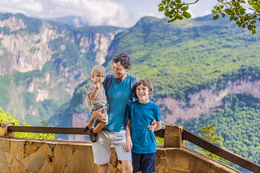 Dad and his two sons baby and teenager travelers exploring Sumidero Canyon National Park, Mexico. Adventure, natural exploration, and travel experience concept.