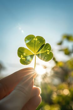A close-up view of a four-leaf clover held up to the sky, symbolizing good luck and the essence of st. patrick's day, with soft sunlight illuminating its leaves and creating a warm, hopeful atmosphere.
