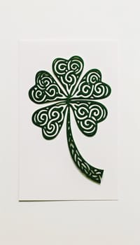 A stylish st. patrick's day greeting card featuring a single shamrock made of intricate celtic knots on a crisp white background. the minimalist design merges traditional irish elements with contemporary aesthetics.