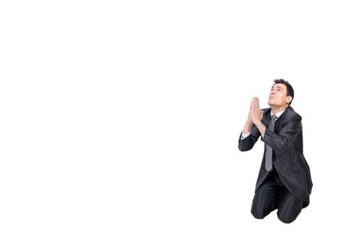 Full body of helpless male entrepreneur in formal suit keeping hands together while begging for forgiveness in studio against white background