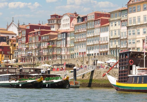 Beautiful panoramic view of the colorful facades of the houses of Porto from the river, during the San Juan festivities