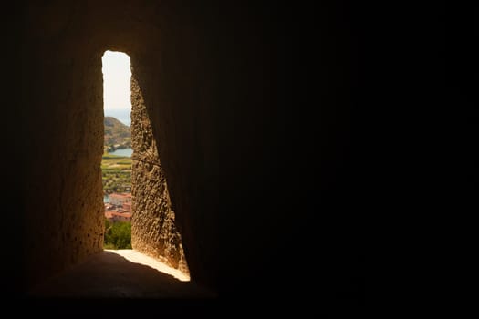 Small window showing a bright day from the cell of a jailed prisoner