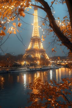 A view of the Eiffel Tower at night, illuminated against a dark sky. The reflection of the tower in the water adds to the beauty of the scene. The trees framing the picture add to the feeling of romanticism