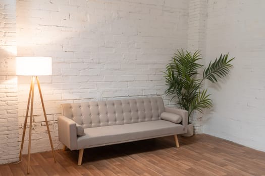 Sofa over white brick wall with copy space. High quality photo
