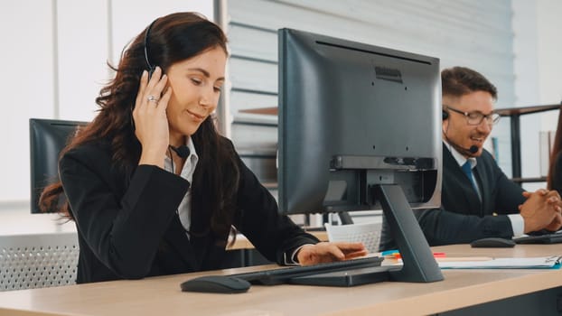 Business people wearing headset working in office to support remote customer or colleague. Call center, telemarketing, customer support agent provide service on telephone video conference call. Jivy