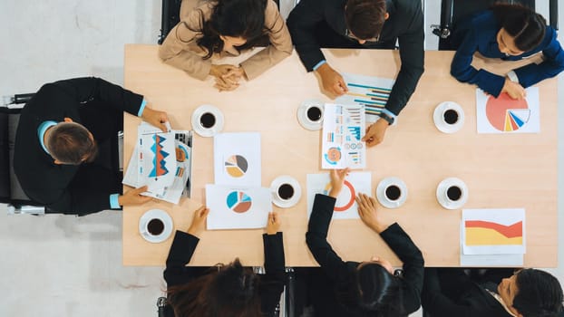 Business people group meeting shot from top view in office . Profession businesswomen, businessmen and office workers working in team conference with project planning document on meeting table . Jivy