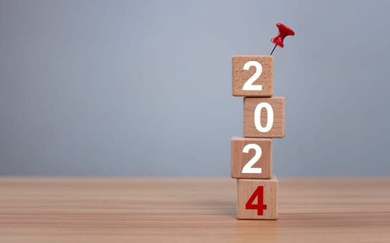 Wooden blocks lined up with the letters 2024. Represents the goal setting for 2024, the concept of a start. financial planning development strategy business goal setting