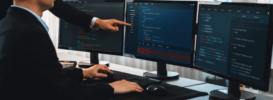 Software development team working together in office, coding script display on computer monitor. Programmer and software engineer working in tech developer company. Trailblazing