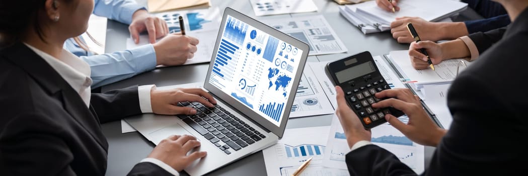 Business intelligence and data analysis concept. Analyst team working on financial data analysis dashboard on laptop screen as marketing indication for effective business strategic planning. Insight