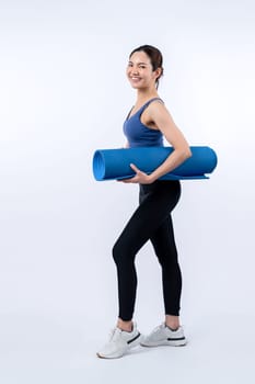 Young attractive asian woman portrait in sportswear with exercising mat. Healthy exercise and workout routine lifestyle concept. Studio shot isolated background. Vigorous