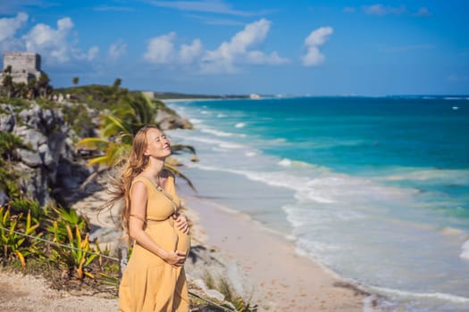 Woman tourist enjoying the view Pre-Columbian Mayan walled city of Tulum, Quintana Roo, Mexico, North America, Tulum, Mexico. El Castillo - castle the Mayan city of Tulum main temple.