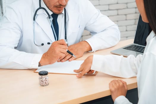 Doctor in professional uniform examining patient at hospital or medical clinic. Health care , medical and doctor staff service concept. Jivy