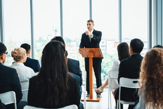 Group of business people meeting in a seminar conference . Audience listening to instructor in employee education training session . Office worker community summit forum with expert speaker . Jivy