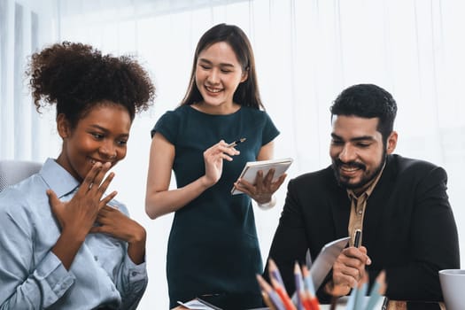 Happy diverse business people work together, discussing in corporate office. Professional and diversity teamwork discuss business plan on desk with laptop. Modern multicultural office worker. Concord