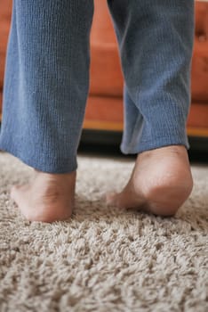 Woman legs tip toeing barefoot on a cart at home