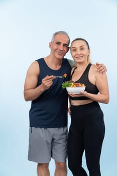 Happy smile senior man and woman portrait holding bowl of vegan fruit and vegetable on isolated background. Healthy senior couple with healthy vegetarian nutrition and body care lifestyle. Clout